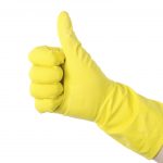 Yellow cleaning glove against isolated on white background